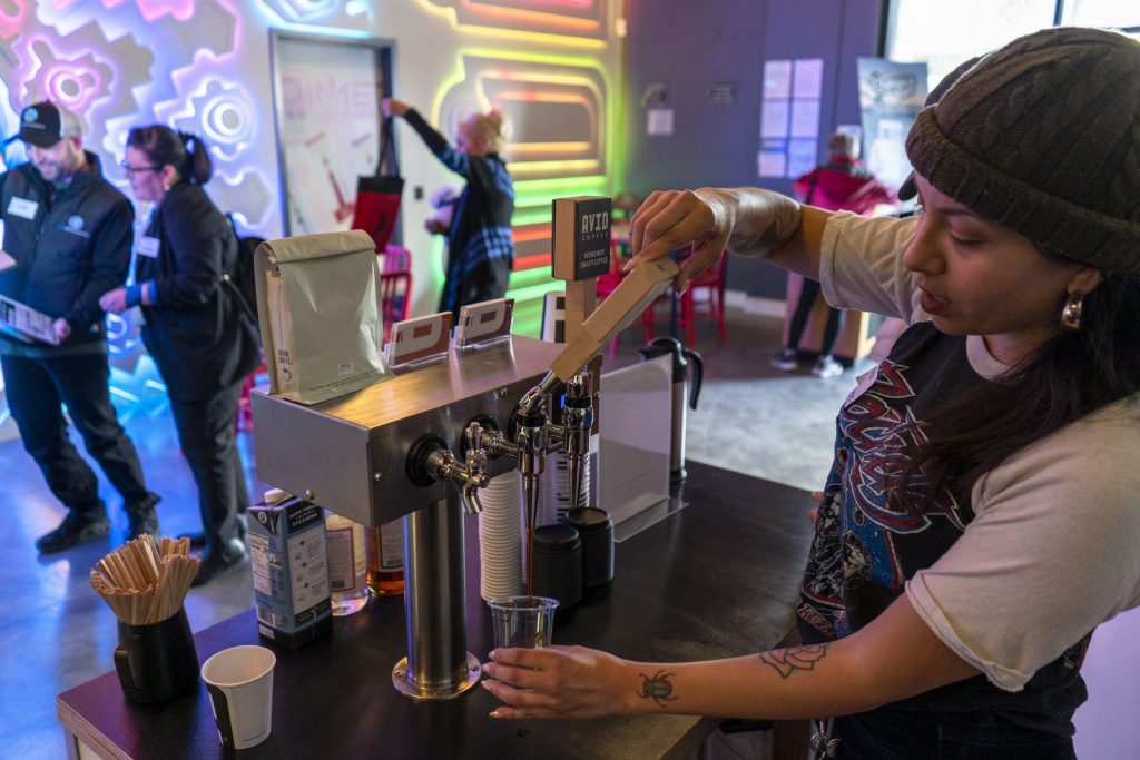 Serving coffee at a networking mixer.