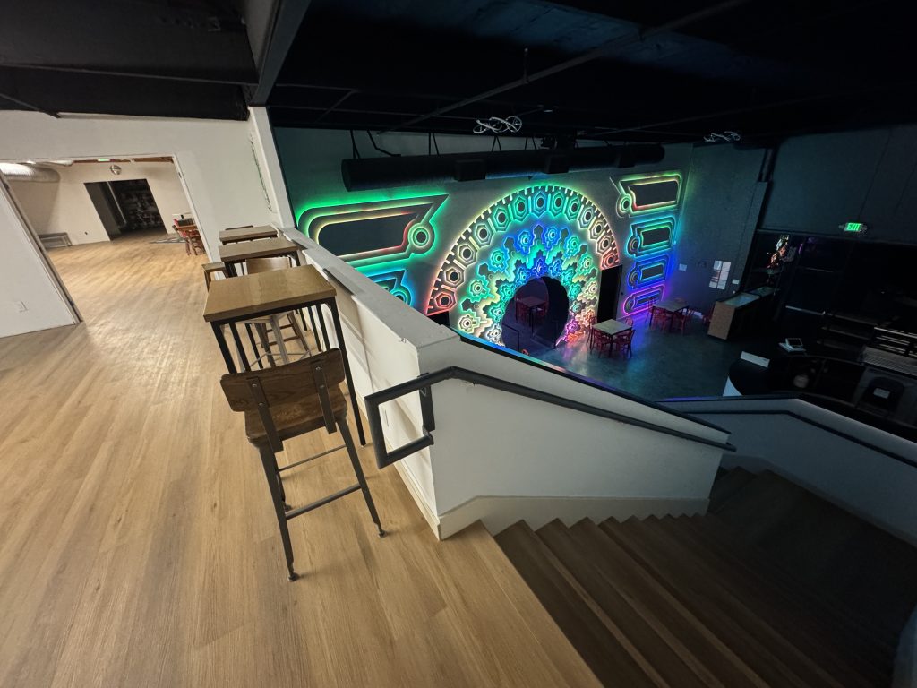 View of the Portal of Wonder in Cafe Dobe, from the top of the stairs with part of The Upstairs space visible.