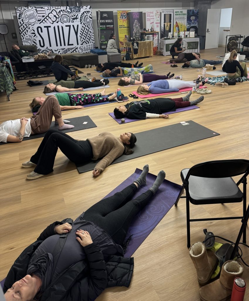 A yoga class at an event held at The Upstairs community space.