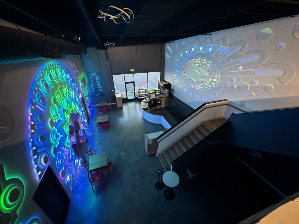 The portal wall and projection wall in the cafe space, seen from above.