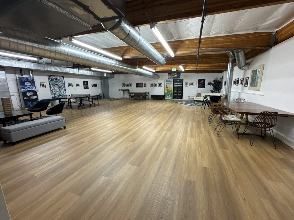 Wide shot of the main event space at The Upstairs, furnished with movable furniture.